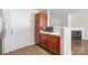 Cozy kitchen showcasing wood cabinets, stainless steel appliances, and backyard access at 11011 Alderbrook Ln, Charlotte, NC 28270