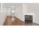 Bright living room with hardwood floors, a cozy fireplace, and staircase at 11011 Alderbrook Ln, Charlotte, NC 28270