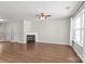Spacious living room showcasing a fireplace, fan, and hardwood floors at 11011 Alderbrook Ln, Charlotte, NC 28270