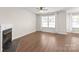 Bright living room with fireplace, hardwood floors, and large windows at 11011 Alderbrook Ln, Charlotte, NC 28270