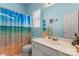 Bright bathroom with a bathtub/shower combo and tiled floors at 11913 Little Stoney Ct, Charlotte, NC 28269