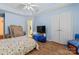 Bright bedroom with hardwood floors, TV and large closet at 11913 Little Stoney Ct, Charlotte, NC 28269