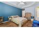 Spacious bedroom with hardwood floors, a ceiling fan, and calming blue walls at 11913 Little Stoney Ct, Charlotte, NC 28269