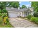 Single-Gathering home with a two-car garage and a concrete driveway, surrounded by greenery at 11913 Little Stoney Ct, Charlotte, NC 28269