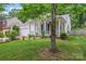 Well-maintained single-Gathering home with lush green lawn, mature trees, and charming front porch at 11913 Little Stoney Ct, Charlotte, NC 28269