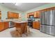 Spacious kitchen featuring stainless steel appliances, wood cabinets, and a convenient center island at 11913 Little Stoney Ct, Charlotte, NC 28269