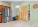 Kitchen features a stainless steel refrigerator, wooden cabinets, and a bright window view at 11913 Little Stoney Ct, Charlotte, NC 28269