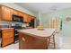 Bright kitchen with wood cabinets, modern appliances, and a view to the backyard at 11913 Little Stoney Ct, Charlotte, NC 28269