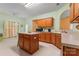Well-lit kitchen featuring a center island, wooden cabinets, and essential appliances at 11913 Little Stoney Ct, Charlotte, NC 28269