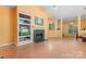 Open-concept living space with fireplace, shelving, and arched doorway, promoting a harmonious flow at 11913 Little Stoney Ct, Charlotte, NC 28269