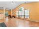 Open living area with vaulted ceilings, large arched window, and wood flooring, offering natural light at 11913 Little Stoney Ct, Charlotte, NC 28269