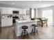 Bright kitchen boasts modern white cabinets, stainless appliances, and an island with seating at 120 Elm Forest Ln, China Grove, NC 28023