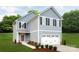 Charming two-story home with blue siding, attached garage and a well-manicured lawn at 120 Millstream Dr, China Grove, NC 28023