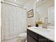 Bathroom with shower, vanity, framed mirror and floral shower curtain offers both functionality and aesthetic appeal at 12641 Glowing Peak Rd, Huntersville, NC 28078