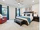 Spacious bedroom featuring a comfortable bed, bench, and dark wood accents at 12641 Glowing Peak Rd, Huntersville, NC 28078