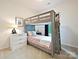 Cozy bedroom with bunk beds, soft colors, and a window, designed for comfort and functionality at 12641 Glowing Peak Rd, Huntersville, NC 28078