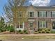 Charming townhouse featuring a stone facade, manicured landscaping, and a welcoming entrance at 12641 Glowing Peak Rd, Huntersville, NC 28078
