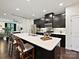 Kitchen with modern white quartz countertop island and dark cabinetry with eat in seating at 12641 Glowing Peak Rd, Huntersville, NC 28078