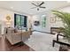 Spacious living room featuring modern furnishings, large windows, and a ceiling fan at 12641 Glowing Peak Rd, Huntersville, NC 28078