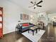 Relaxing living room featuring a plush sofa, modern decor, and a cozy atmosphere at 12641 Glowing Peak Rd, Huntersville, NC 28078