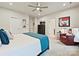 Spacious main bedroom with ceiling fan, modern decor, and a comfortable red chair creates an inviting retreat at 12641 Glowing Peak Rd, Huntersville, NC 28078