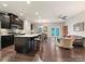 Open-concept living space with a kitchen island, dining area, and comfortable living area at 12641 Glowing Peak Rd, Huntersville, NC 28078