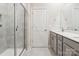 Clean bathroom featuring a tiled shower, single vanity, and grey cabinets at 13210 Kenworth Rd, Charlotte, NC 28278