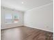 Bright bedroom with hardwood floors, large windows, and neutral paint at 13210 Kenworth Rd, Charlotte, NC 28278
