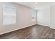 Bright room with wood floors, two windows, neutral walls, and ample space for furniture at 13210 Kenworth Rd, Charlotte, NC 28278