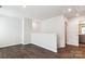Spacious room boasting sleek, dark wood floors and a white wall. Minimalist design, perfect for a modern living space at 13210 Kenworth Rd, Charlotte, NC 28278