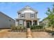 Inviting two-story home with gray siding, black shutters and a cozy covered front porch at 13210 Kenworth Rd, Charlotte, NC 28278