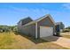 Detached two-car garage with a white door, set in a well-maintained backyard under a clear blue sky at 13210 Kenworth Rd, Charlotte, NC 28278