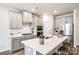 Bright, modern kitchen with stainless steel appliances, ample cabinets, and a quartz countertop island at 13210 Kenworth Rd, Charlotte, NC 28278