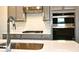 The kitchen features stainless steel appliances and gray cabinetry at 13210 Kenworth Rd, Charlotte, NC 28278