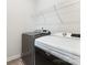 Functional laundry room with modern washer and dryer units and a wire shelf at 13210 Kenworth Rd, Charlotte, NC 28278