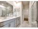 Spacious main bathroom with double sink vanity, walk-in shower and access to walk-in closet at 13210 Kenworth Rd, Charlotte, NC 28278