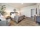 Cozy main bedroom features a sitting chair and ample natural light at 13210 Kenworth Rd, Charlotte, NC 28278