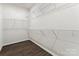 Walk-in closet offers ample storage with wire shelving and hardwood floors at 13210 Kenworth Rd, Charlotte, NC 28278