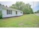 Back exterior view of home, white siding with backyard access and a small outbuilding at 1343 Flint Hill St, Rock Hill, SC 29730