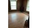 Spacious living room featuring wood-paneled walls and laminate wood flooring, perfect for relaxing or entertaining at 1343 Flint Hill St, Rock Hill, SC 29730
