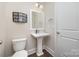 Cozy powder room features a pedestal sink, toilet, and neutral wall colors at 1507 Riverwalk Pkwy, Rock Hill, SC 29730