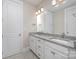 Bathroom featuring double sinks with granite counters and white cabinetry at 1507 Riverwalk Pkwy, Rock Hill, SC 29730