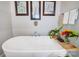 Bathroom featuring a modern, white bathtub, art, and fresh flowers at 1507 Riverwalk Pkwy, Rock Hill, SC 29730