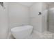 Bright bathroom featuring a standalone tub and glass-doored shower at 1507 Riverwalk Pkwy, Rock Hill, SC 29730