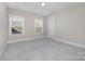 Bedroom featuring neutral walls, carpeted floors, and windows for natural light at 1507 Riverwalk Pkwy, Rock Hill, SC 29730