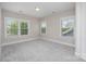 Sunlit bedroom featuring three large windows, neutral walls, and carpet flooring at 1507 Riverwalk Pkwy, Rock Hill, SC 29730