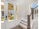 Bright entryway with a staircase and glass-paneled front door at 1507 Riverwalk Pkwy, Rock Hill, SC 29730