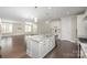 Open-concept kitchen featuring a marble island and hardwood floors, leading to living room at 1507 Riverwalk Pkwy, Rock Hill, SC 29730