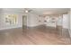Spacious living room with hardwood floors flowing into modern kitchen with white cabinetry at 1507 Riverwalk Pkwy, Rock Hill, SC 29730