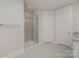 Modern shower with glass door and gray tiled walls at 1507 Riverwalk Pkwy, Rock Hill, SC 29730